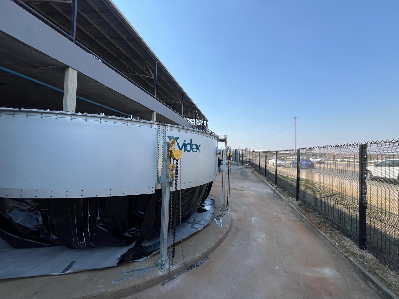 Videx branded cylindrical Aluzinc water storage tank installed alongside the East Rand Mall building