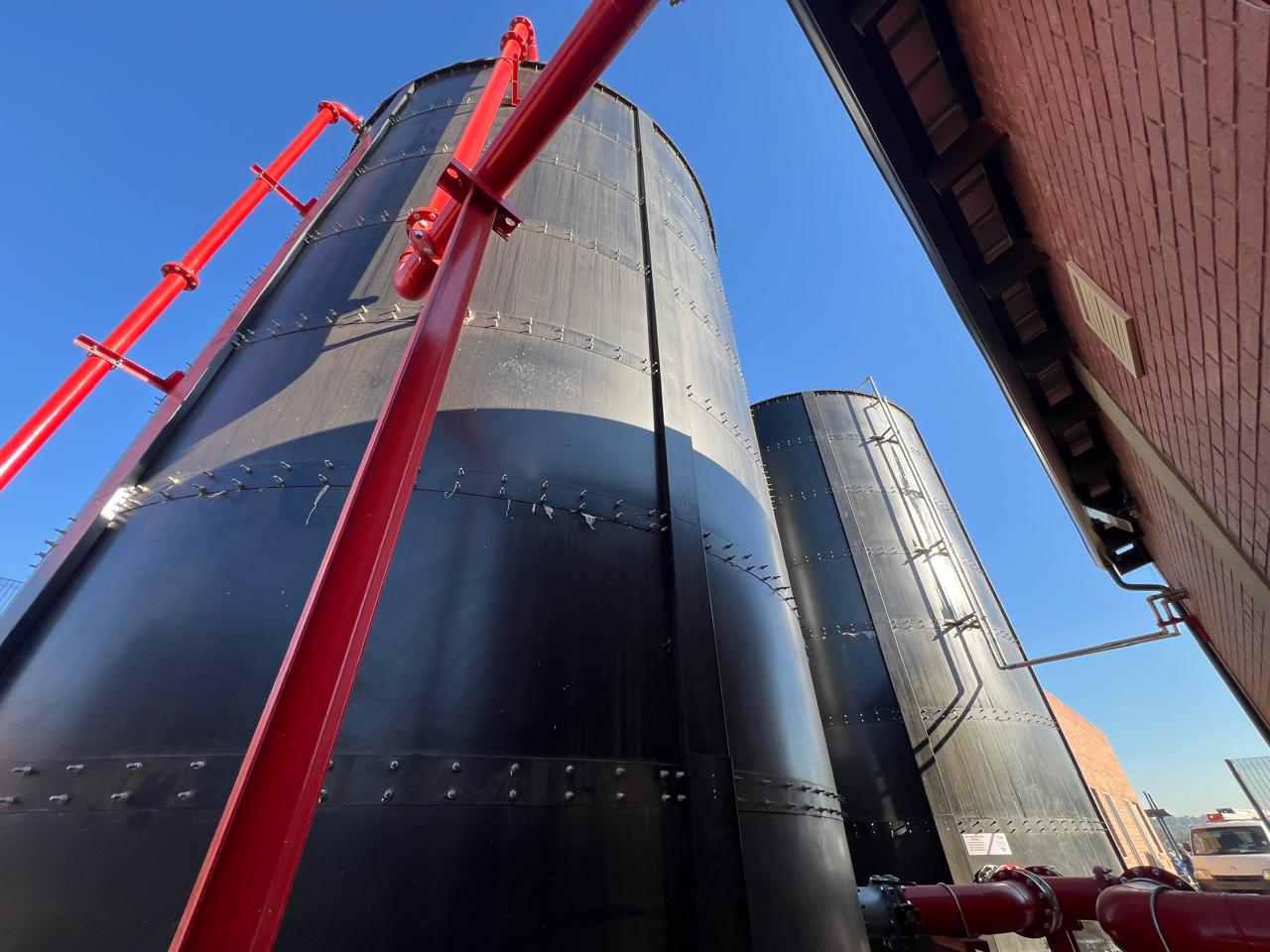 Fleurhof Mall cylindrical steel fire water tanks with red pipework